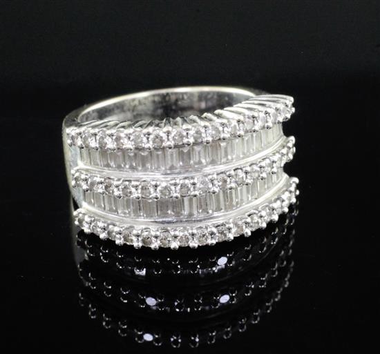 An 18ct white gold and channel set diamond five row ring, set with baguette and round cut stones, size L.